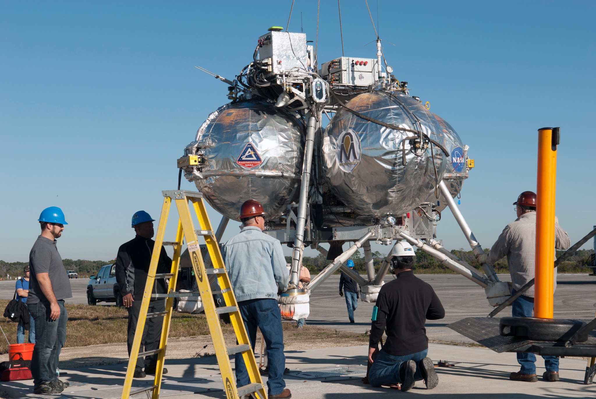 Technicians prepare the Morpheus prototype lander for a free flight test.