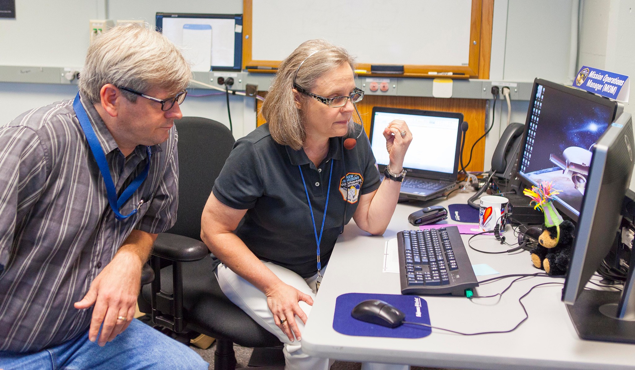 Mission Operations Manager Alice Bowman and operations team member Karl Whittenburg watch for data.