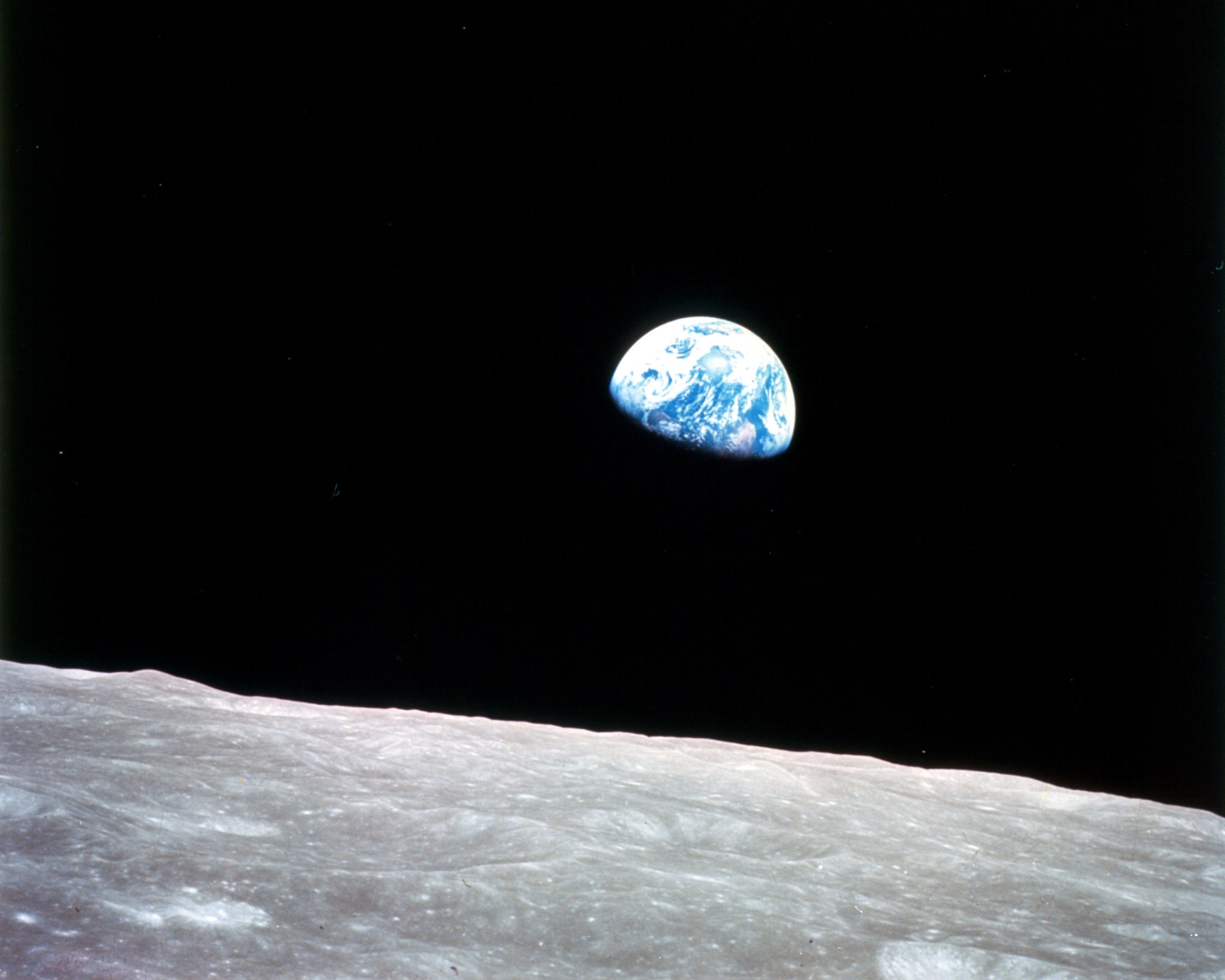Moon surface with Earth in the distance.