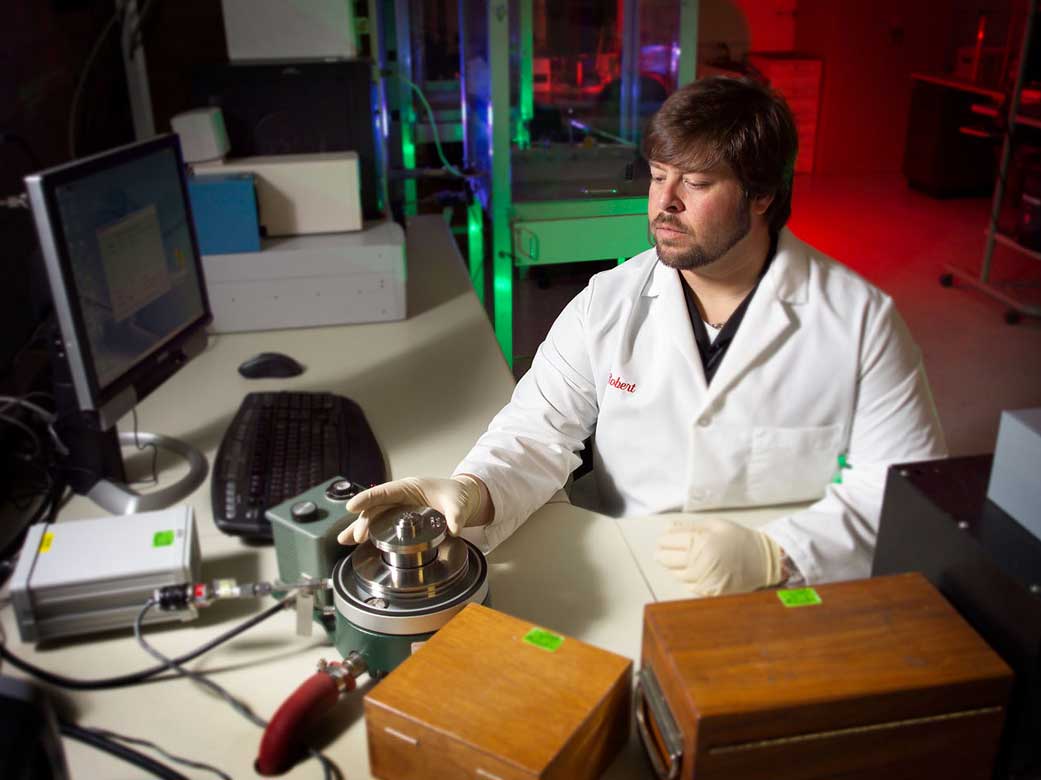 A calibration technician calibrates pressure