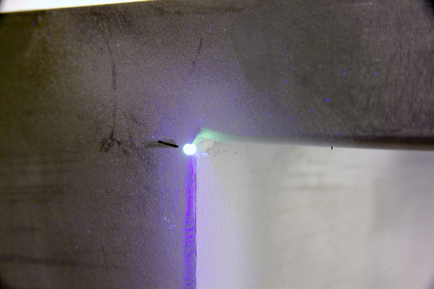 The Non-destructive evaluation technique of Liquid Penetrant Inspection can reveal weld surface cracks and pinholes.