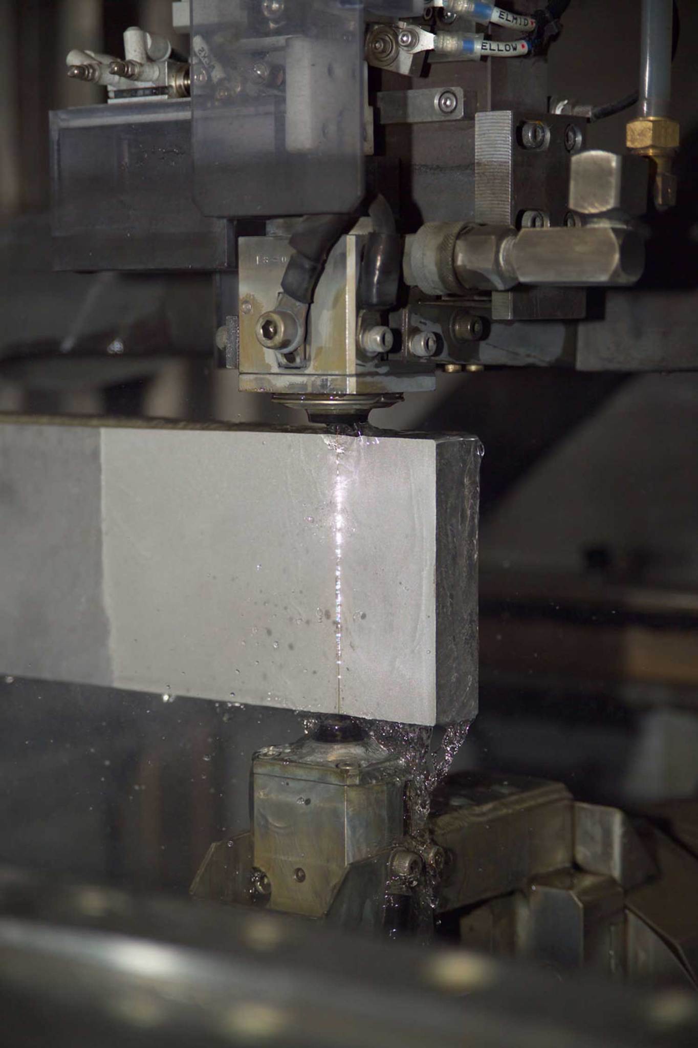 EDM machine cutting a small piece of aluminum