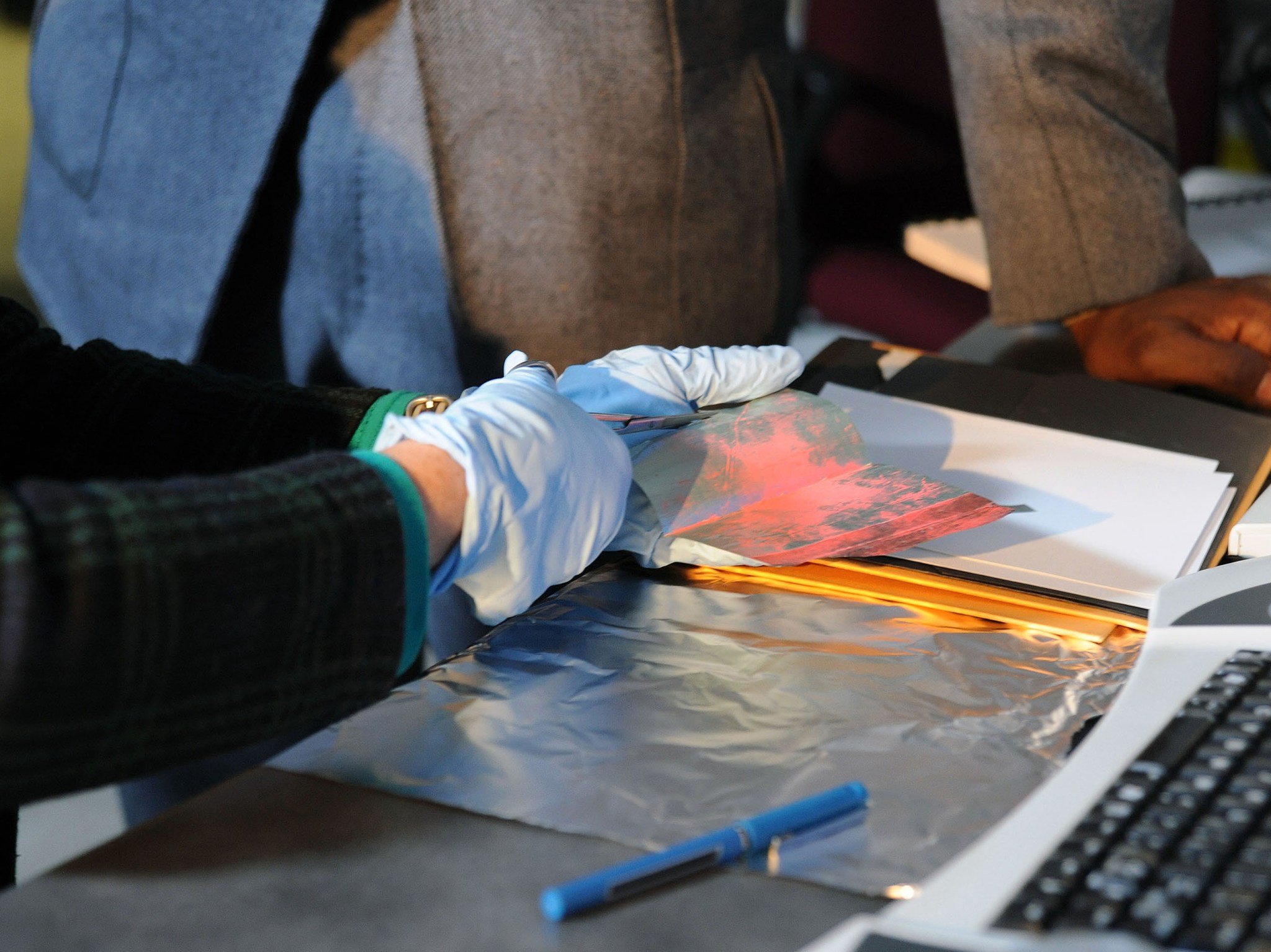 Debbie Thomas cuts the sample to be tested during a visit from PBS's History Detectives.