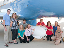 Teachers and project officials gathered under the UAVSAR pod mounted underneath the aircraft.