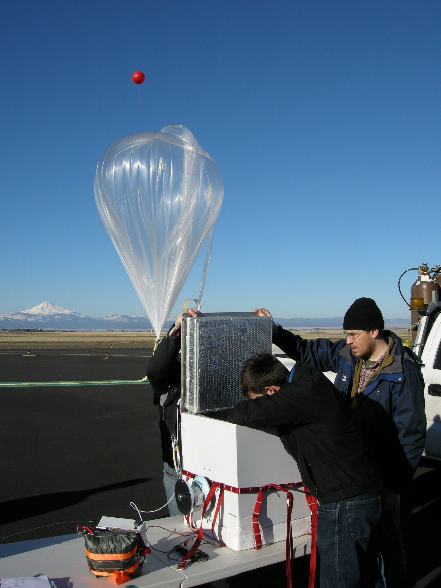 assistants check the prototype structural integrity data acquisition payload.