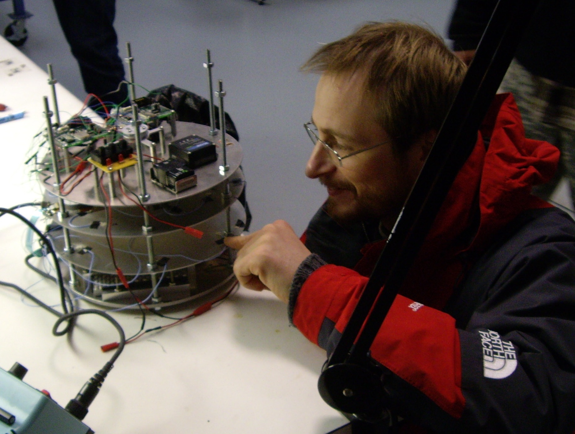 NMT professor checks out the prototype data acquisition system during bench testing prior to its high-altitude balloon flight.