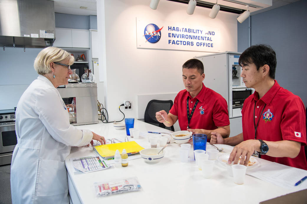 Astronauts participate in a food tasting in the Habitability and Environmental Factors Office at NASA's Johnson Space Center.