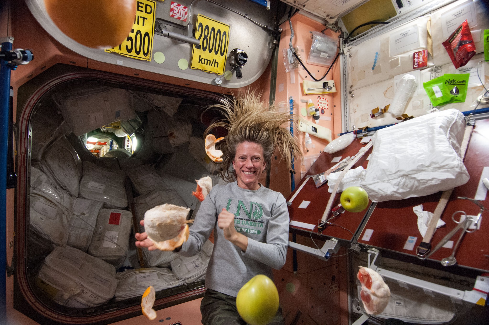 Astronaut Karen Nyberg pictured near fresh fruit floating in the space station