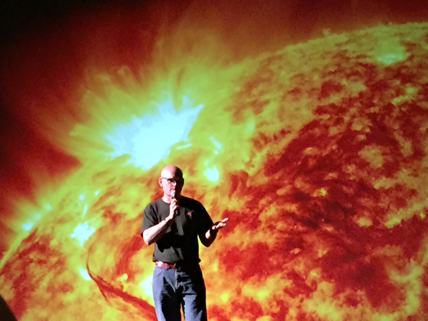 Alex Young talks about heliophysics in front of a “Solarium” backdrop at the World Science Festival in New York City.