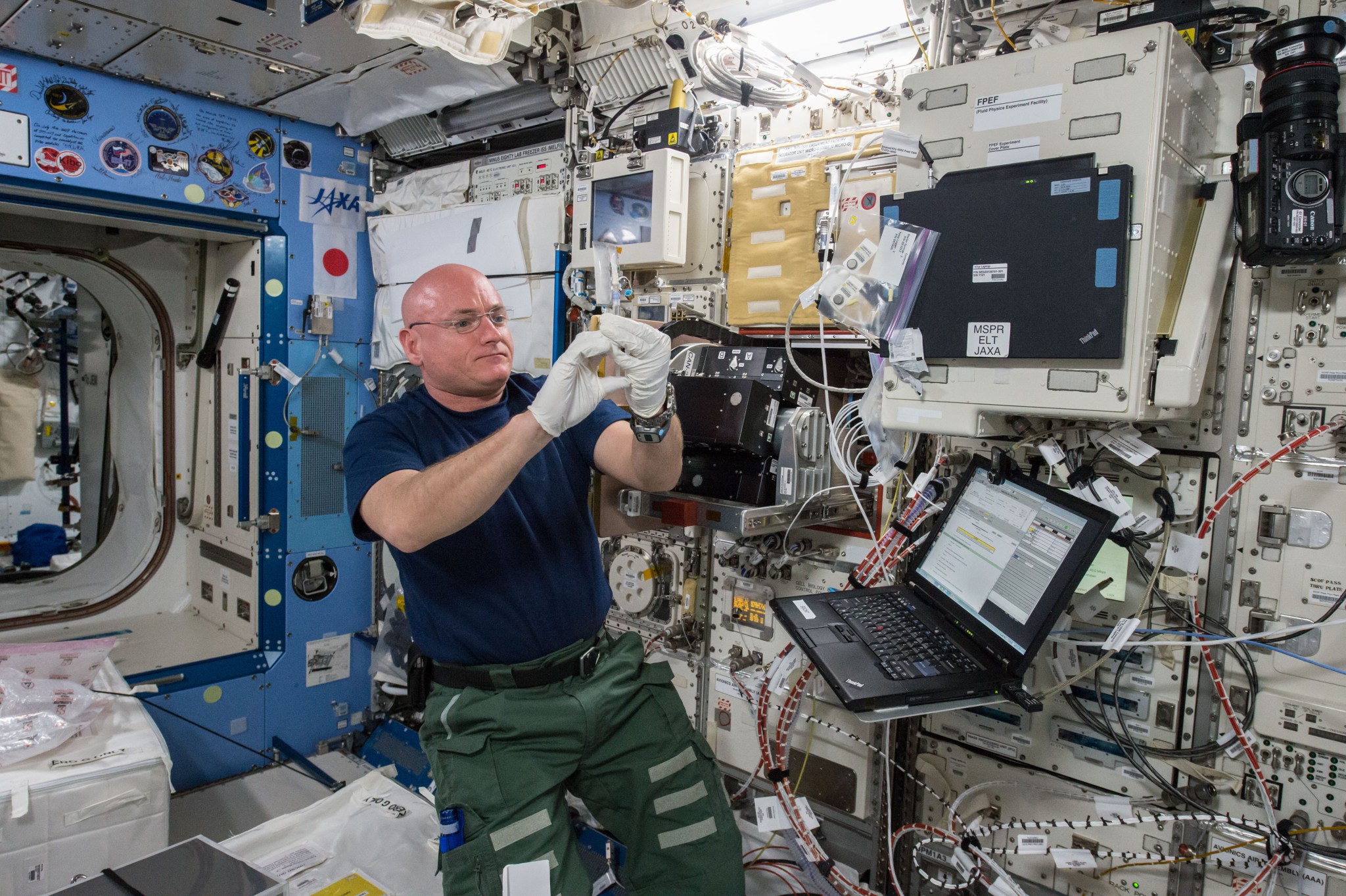 NASA astronaut Scott Kelly works with the Space Aging investigation.