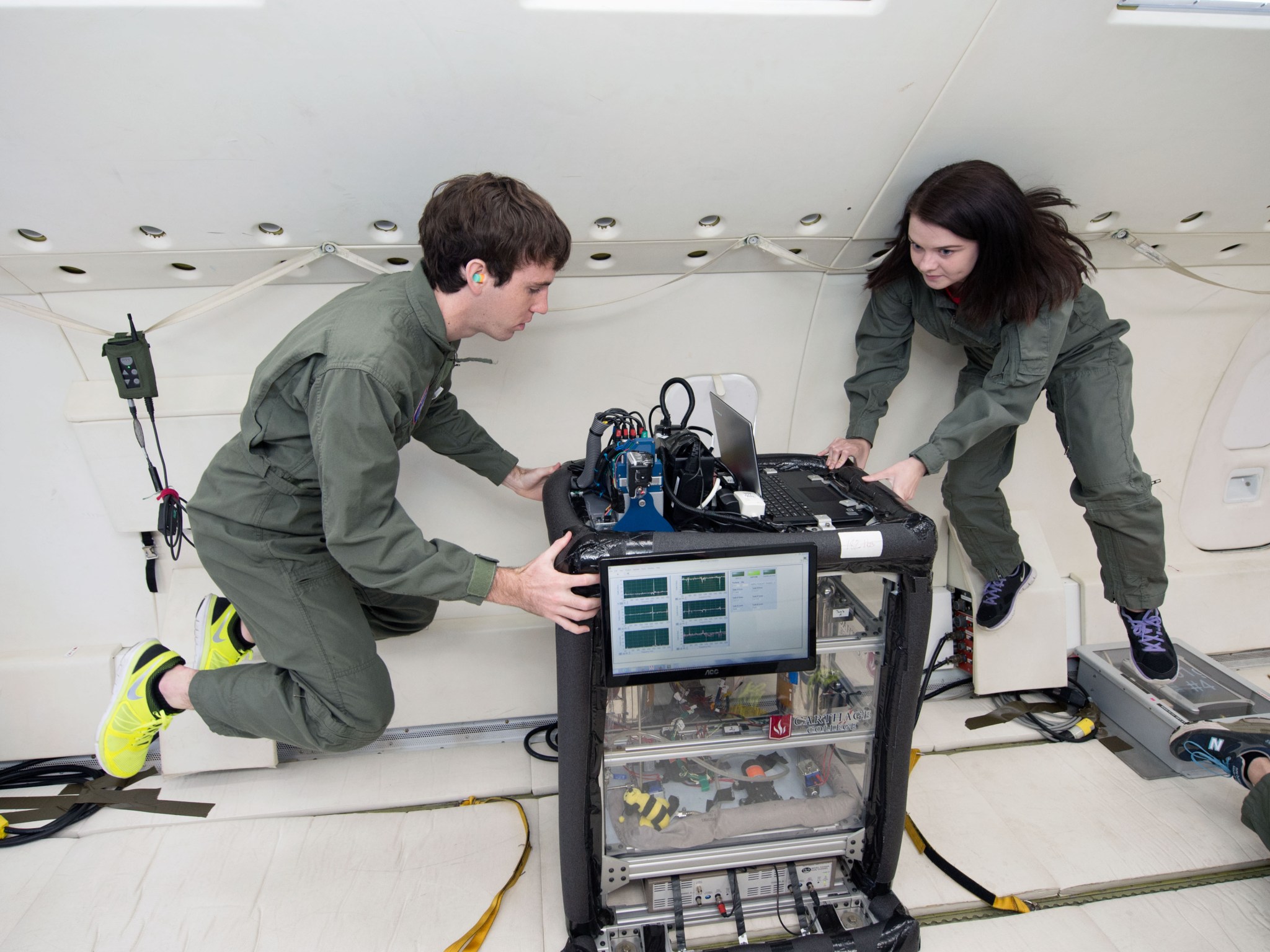 Carthage College researchers testing their propellant mass gauging experiment in zero gravity.