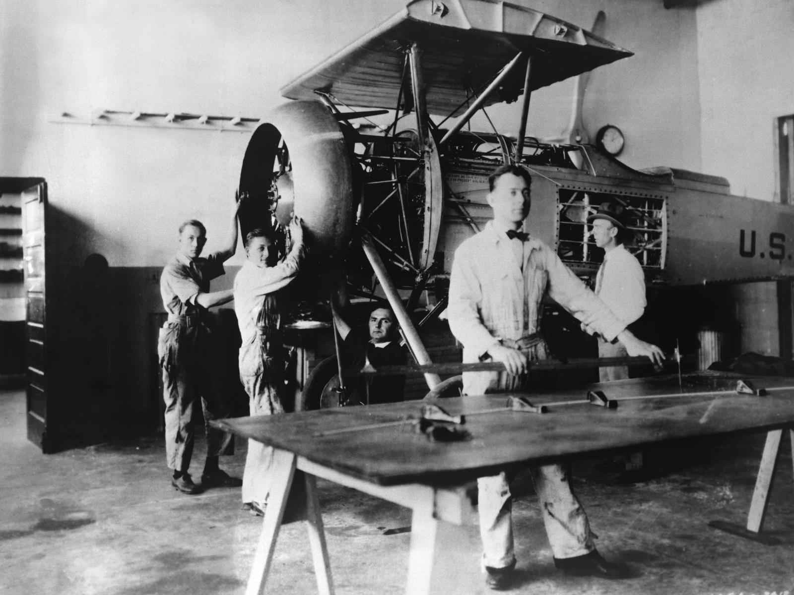 Black and white photo of metal workers.