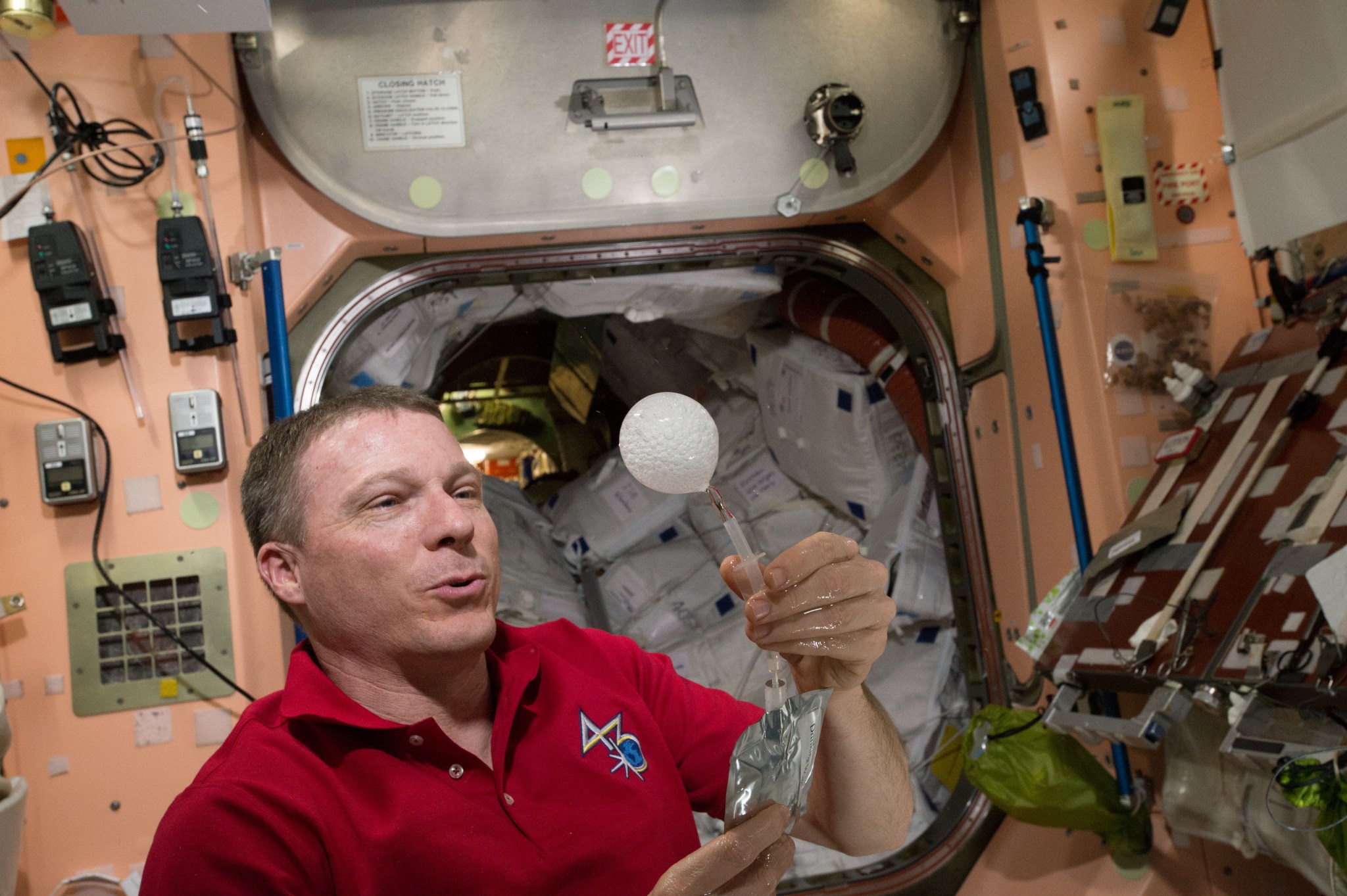 A water bubble with the remnants of an antacid tablet reaction floats in front of astronaut Terry Virts’ eye.