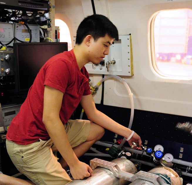 SARP participant Braven Leung assists in testing the University of Houston air quality instruments onboard the DC-8.