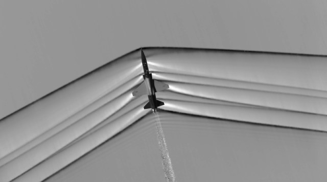 This schlieren image dramatically displays the shock wave of a supersonic jet flying over the Mojave Desert.