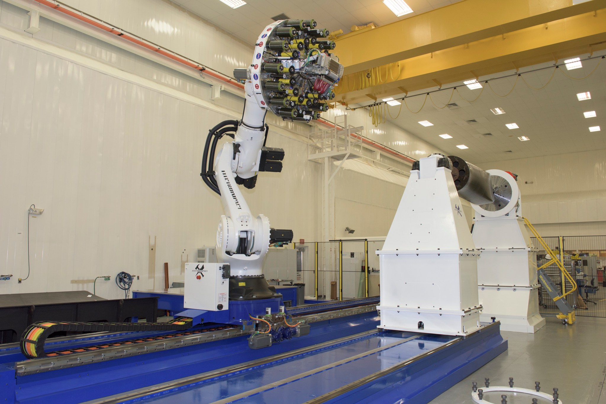 The 21-foot robot arm moves on a track in the Composites Technology Center in NASA’s National Center for Advanced Manufacturing.