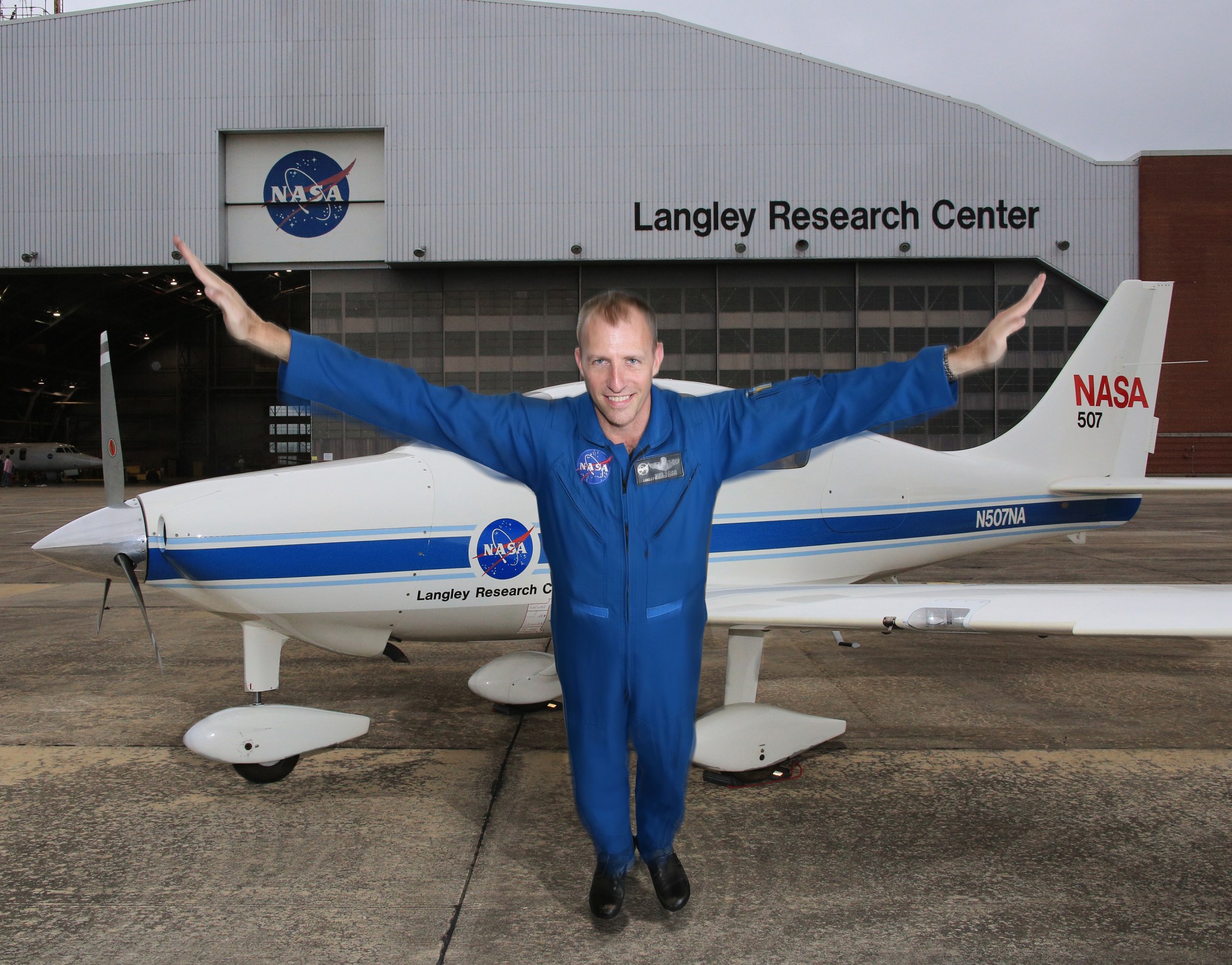 Greg Slover with his arms stretched out wide.