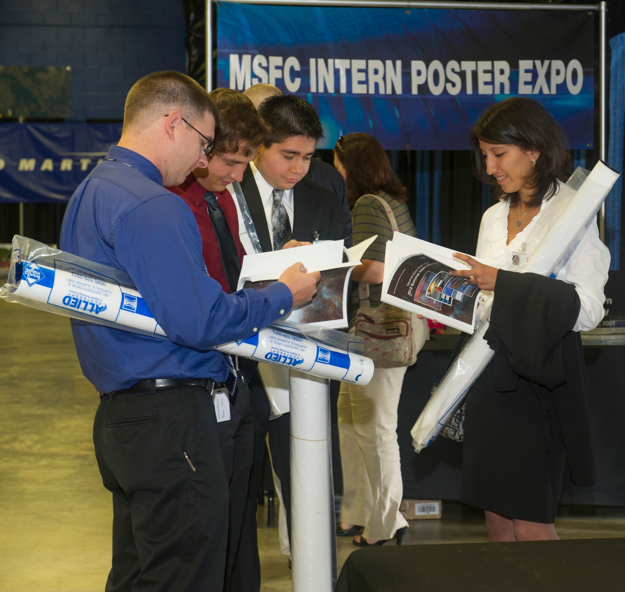 Interns attend the August 2014 Poster Exposition at NASA’s Marshall Space Flight Center.
