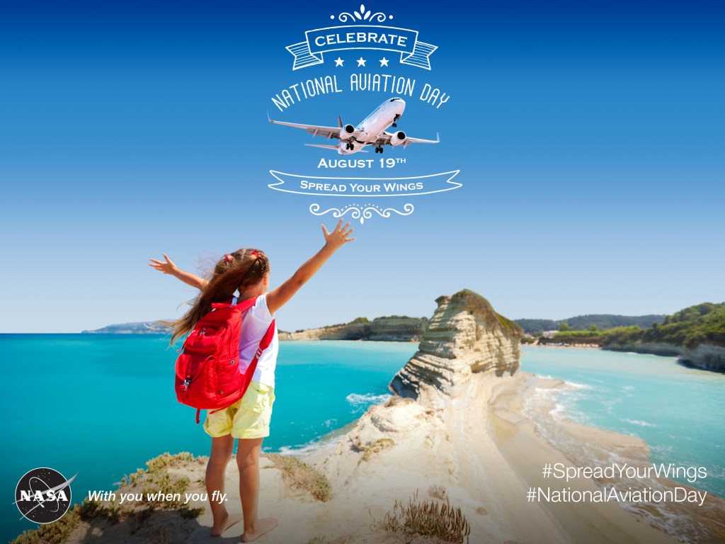 A little girl spreading her arms out for National Aviation Day 2015, like she's about to take flight.