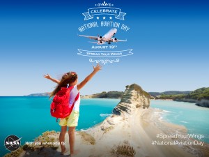 A little girl spreading her arms out for National Aviation Day 2015, like she's about to take flight.