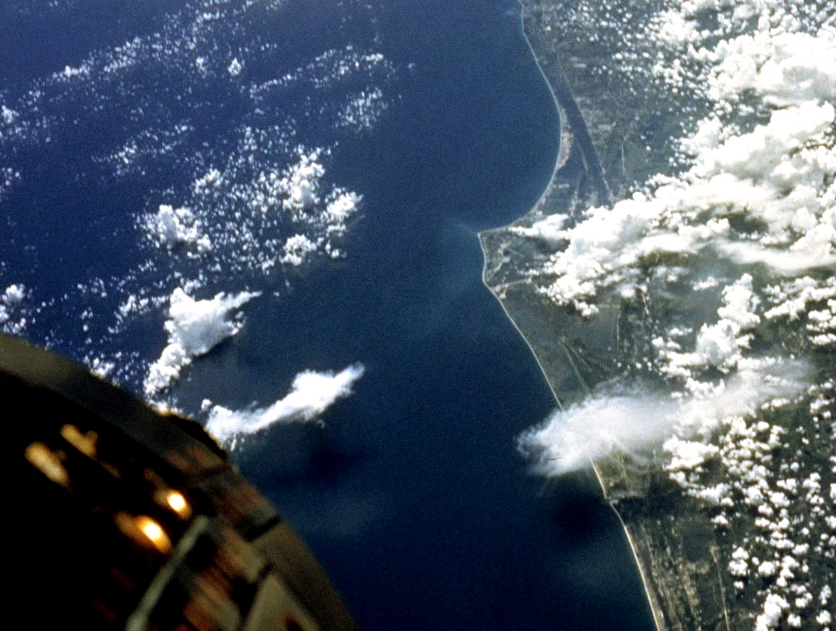 view from space of East Central Florida The nose of the Gemini V spacecrft is in the lower left.