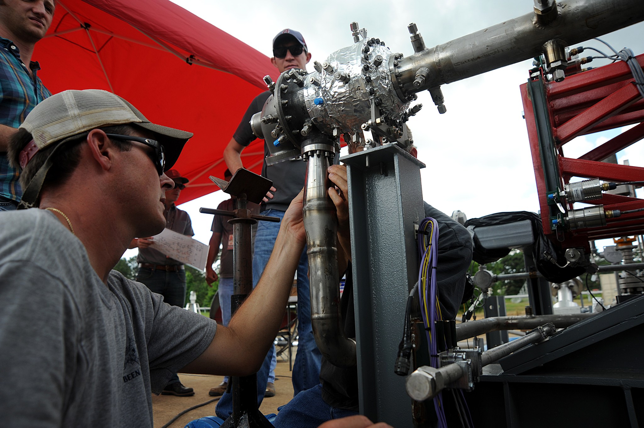 Engineers prepare a 3-D printed turbopump for a test at NASA’s Marshall Space Flight Center in Huntsville, Alabama