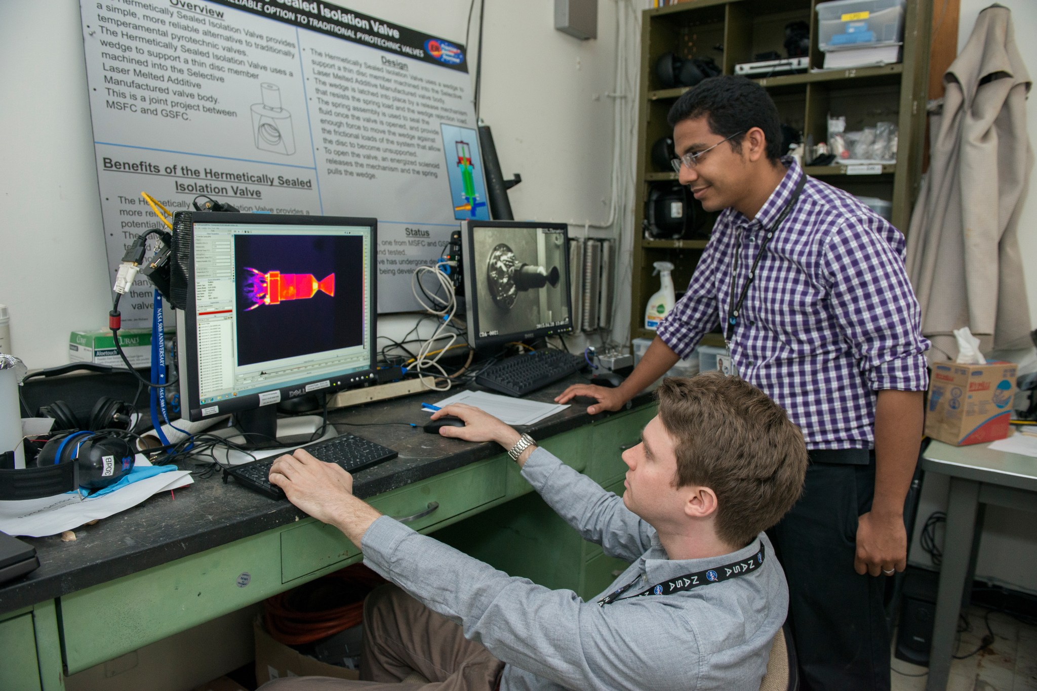NASA engineers monitor temperature data on the left computer screen as a thruster fueled with the green propellantis fired.