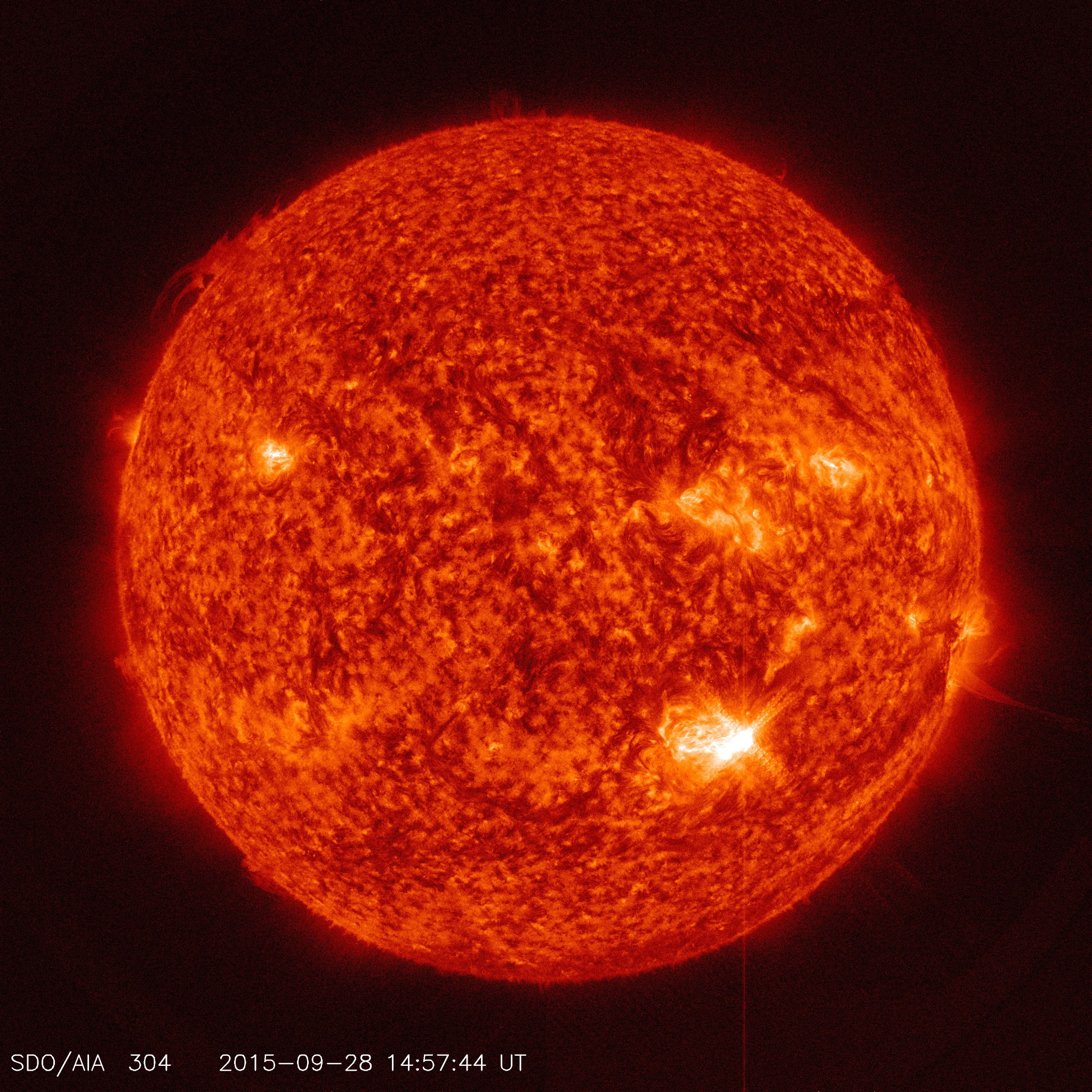 full disc image of the sun with flare at lower right