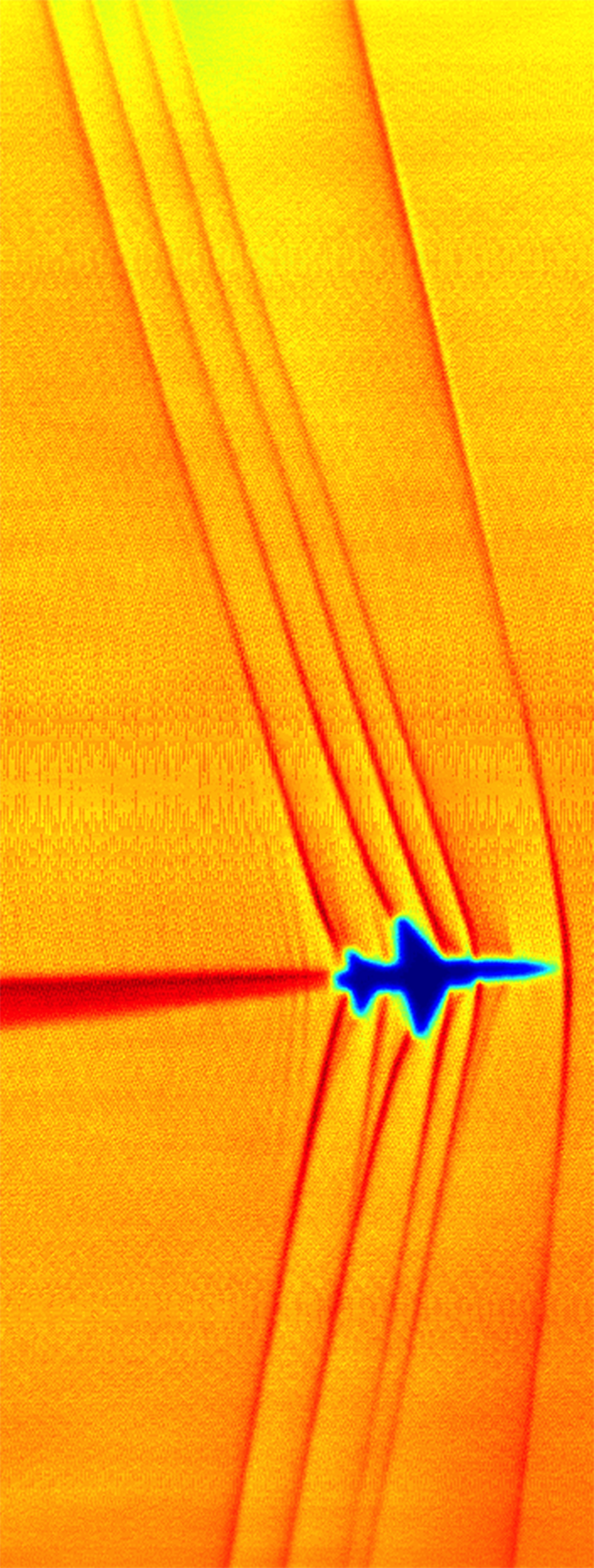 This schlieren image of shock waves created by a T-38C in supersonic flight was captured using the sun’s edge as a light source 