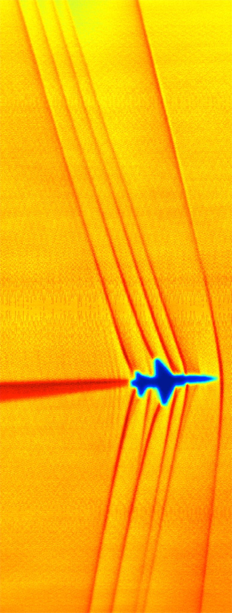 This schlieren image of shock waves created by a T-38C in supersonic flight was captured using the sun’s edge as a light source 