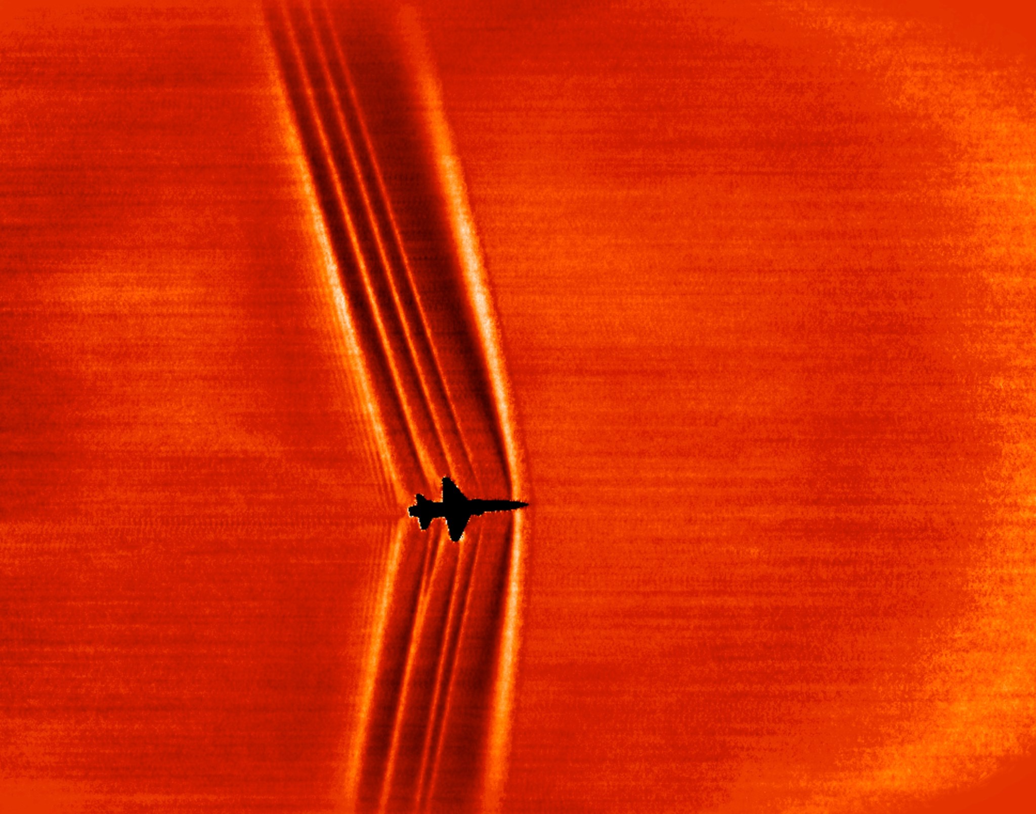 Schlieren image of shock waves created by a T-38C in supersonic flight.