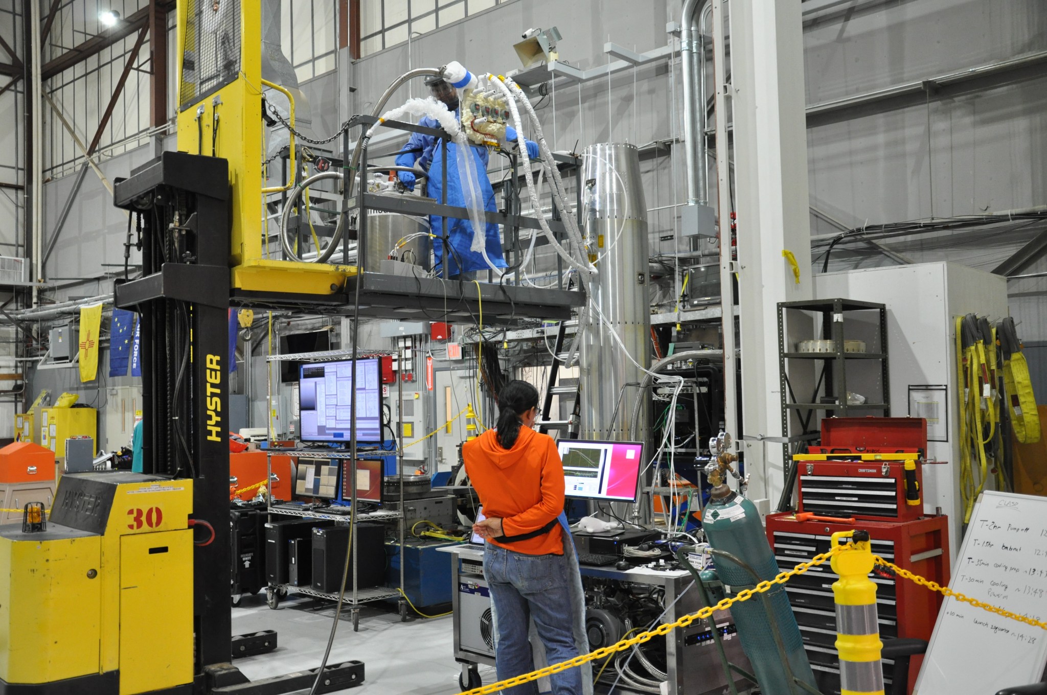 Workers at Marshall conduct vertical cooling testing on the CLASP instrument during integration of the instrument hardware.