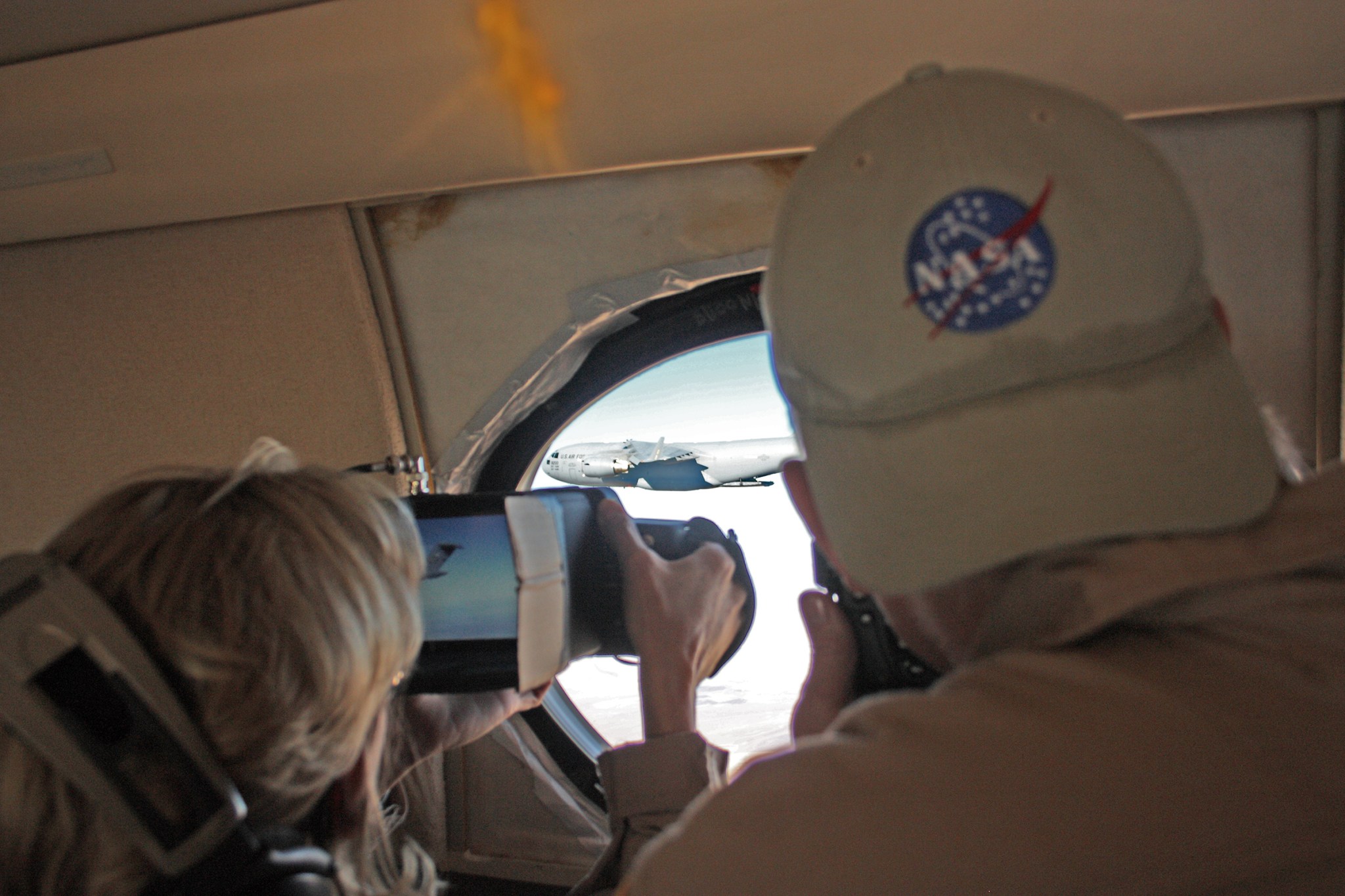 Lori Losey and Jim Ross, from left, gather imagery on the Orion parachute tests as the system is prepared for a drop test fr