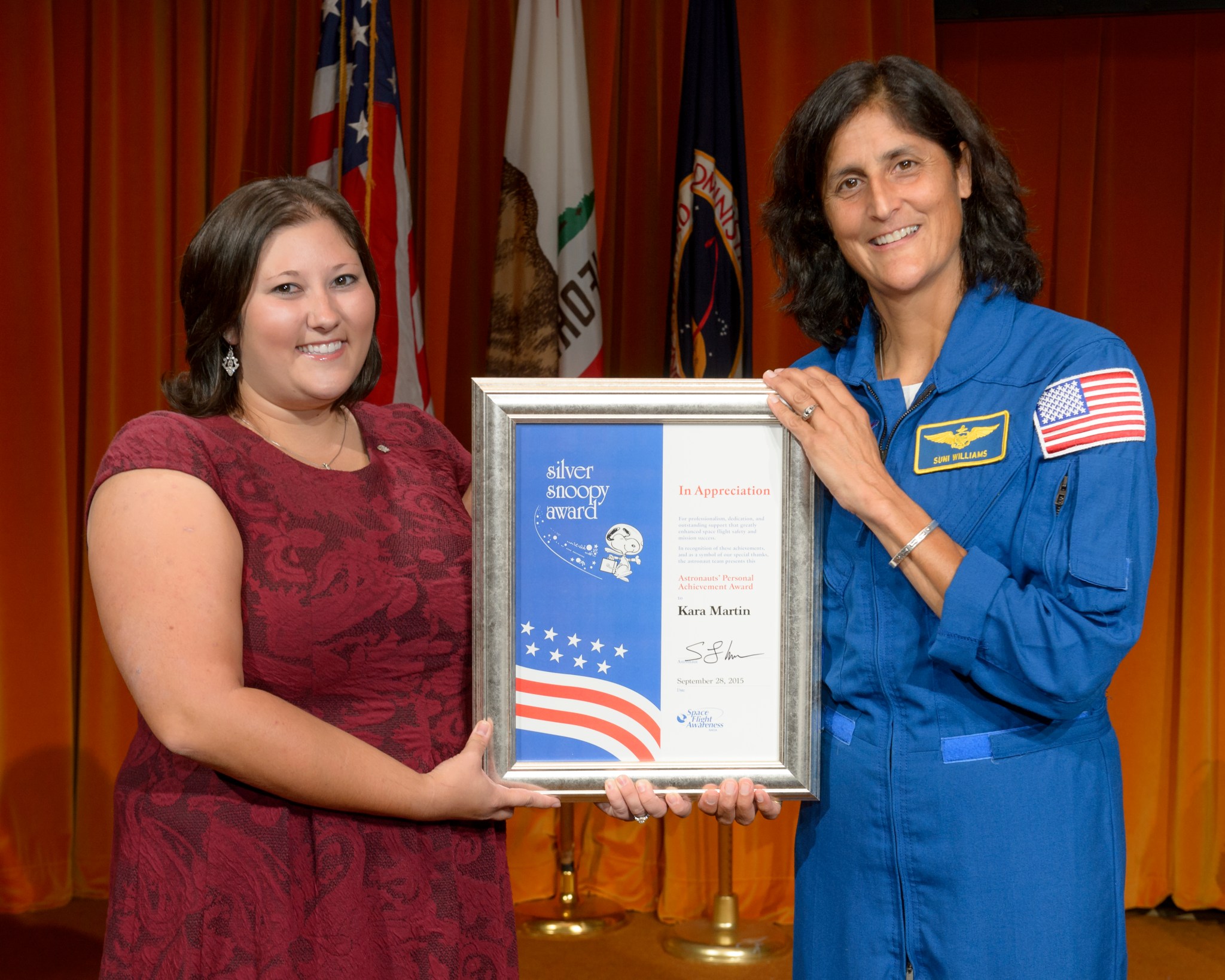 Kara Martin is presented with a Silver Snoopy Award by NASA Astronaut Sunita Williams.