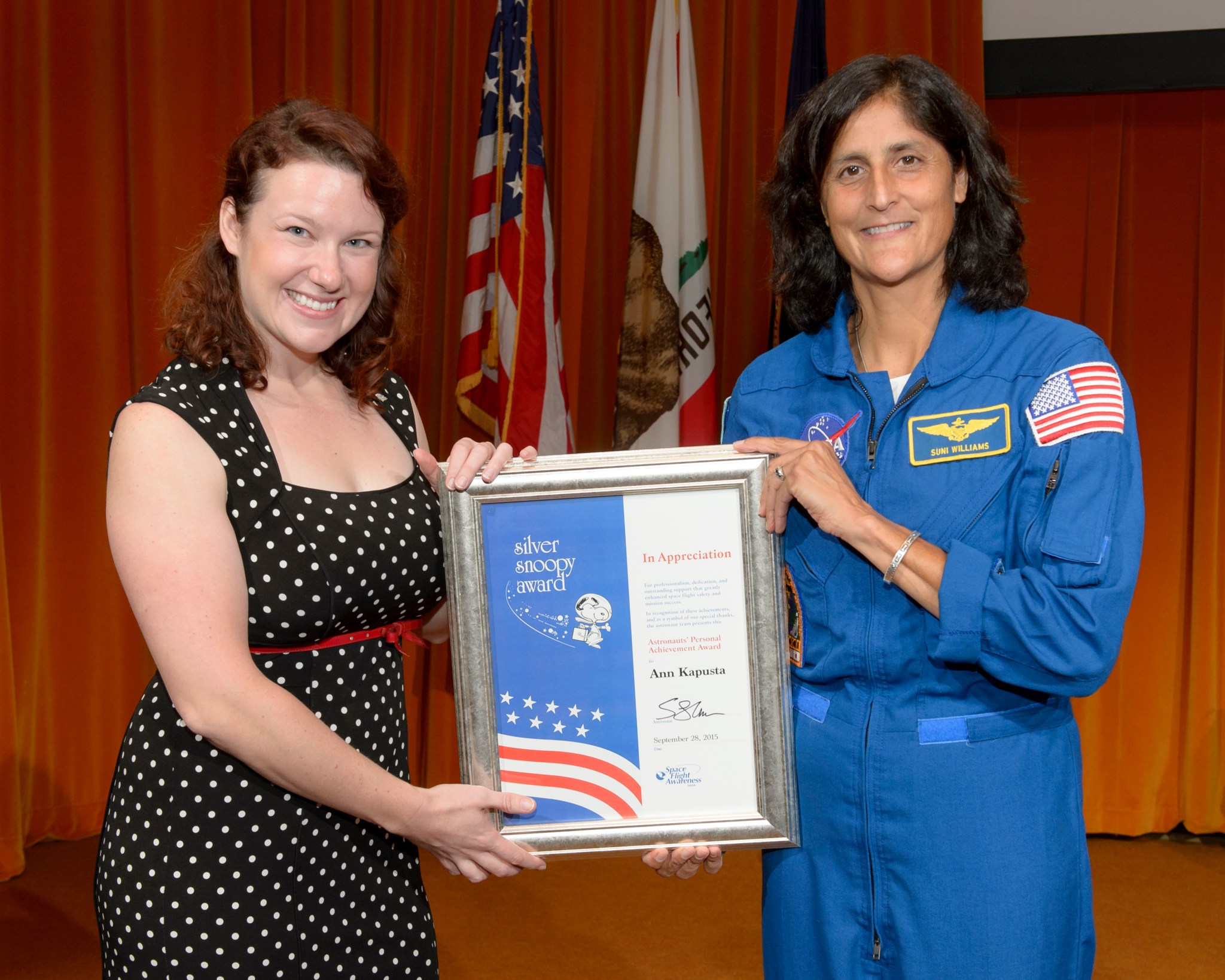 Ann Kapusta is presented with a Silver Snoopy Award by NASA Astronaut Sunita Williams.