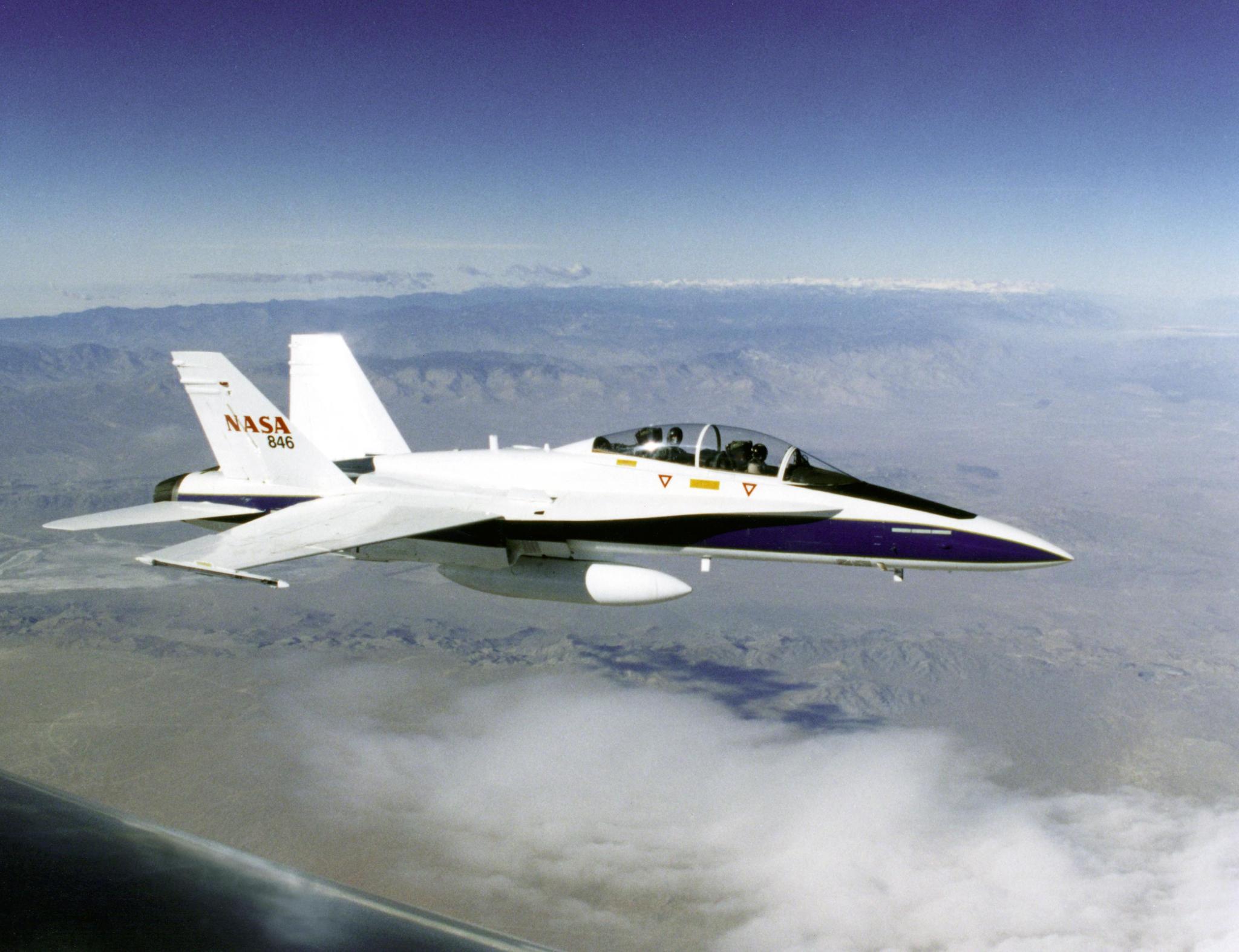 F/A-18B aircraft in flight, used as a safety chase and support aircraft on Dryden research missions.