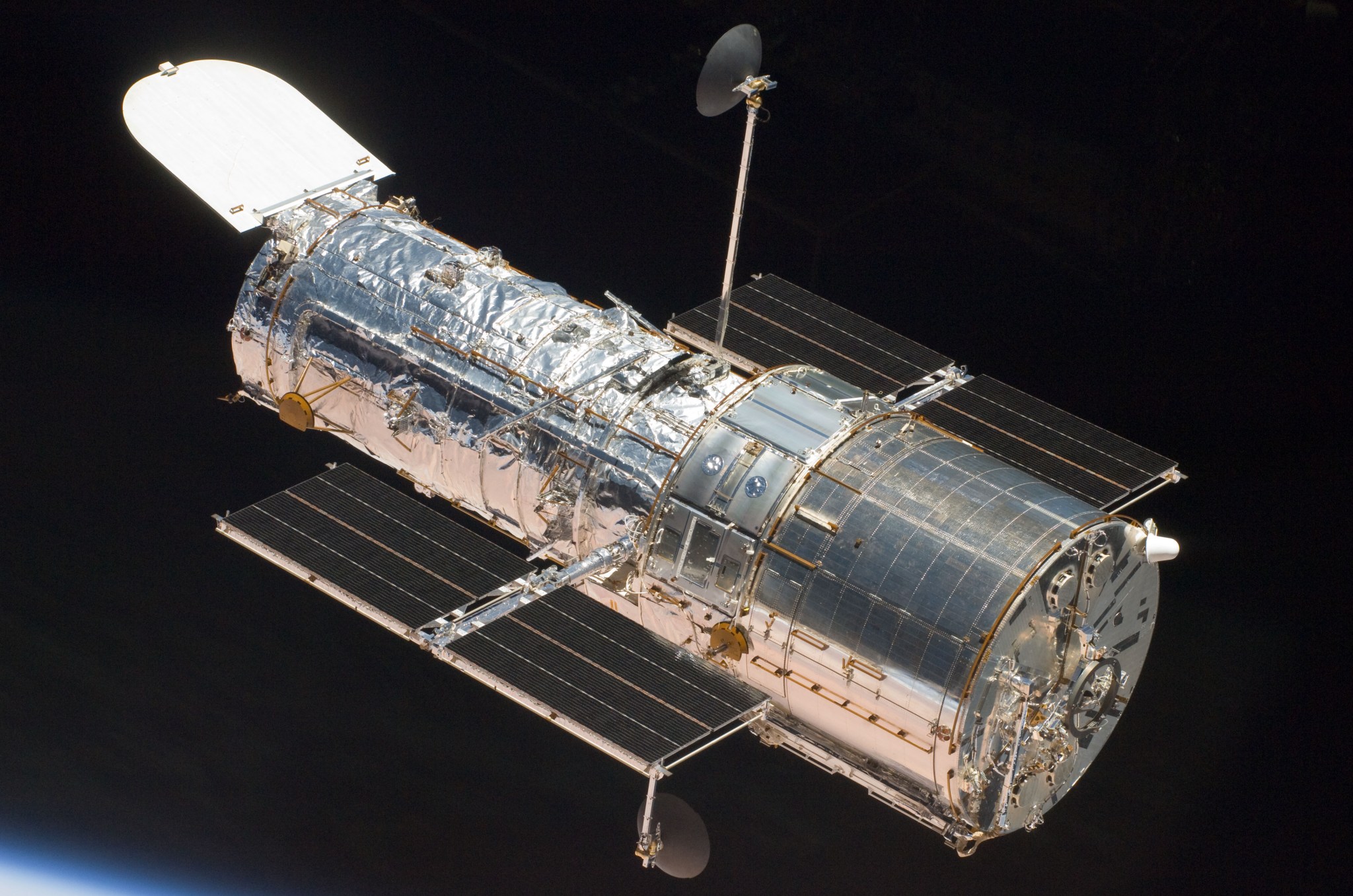 The Hubble Space Telescope in orbit above Earth, as seen from the space shuttle Atlantis