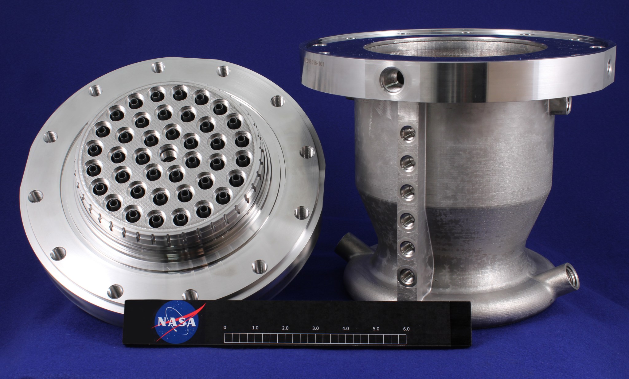 The 3-D printed, methane-powered thruster consists of an injector, left, and chamber, right. 