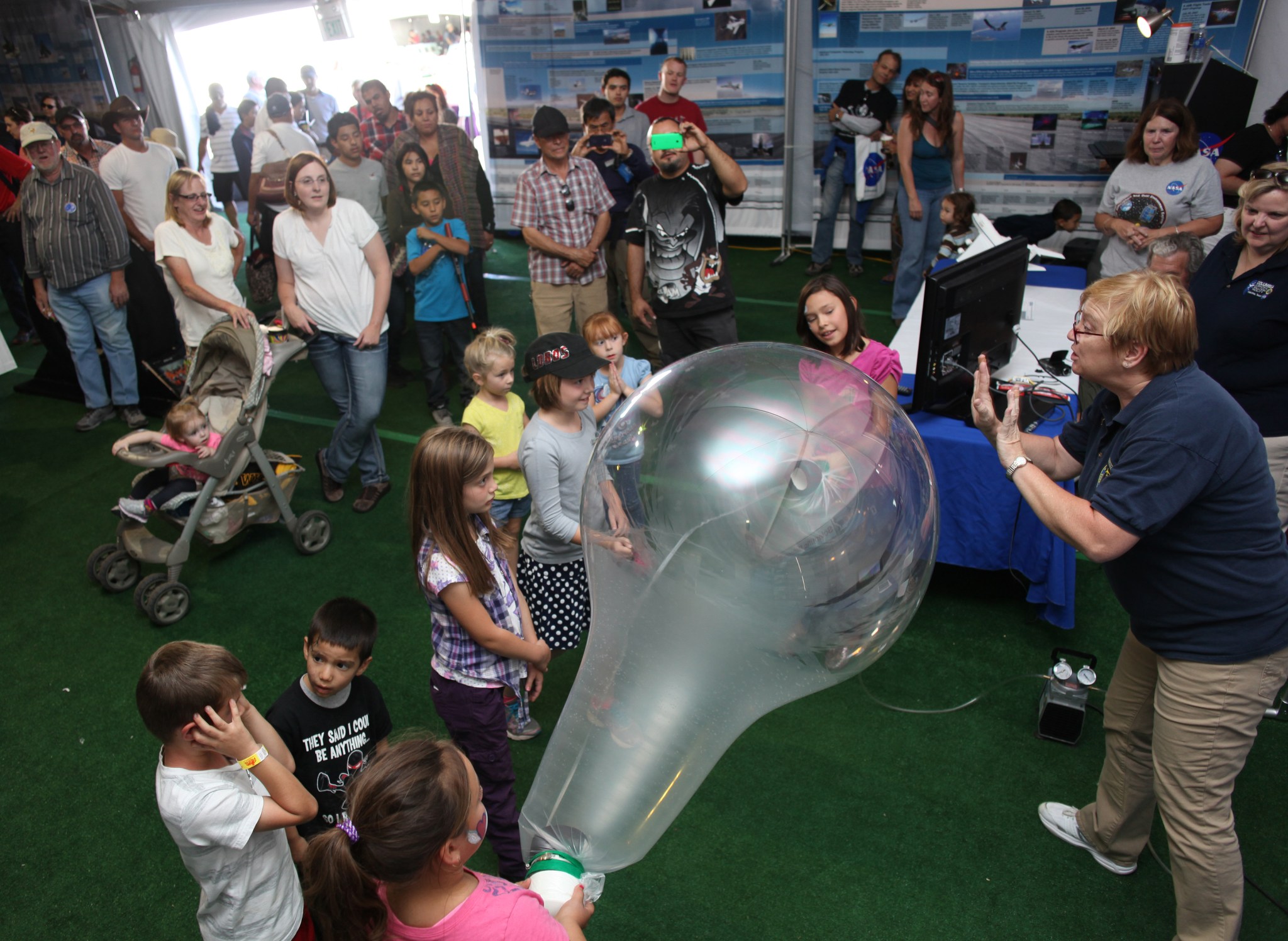 Rebecca Gramlich worked with a group of kids to demonstrate the resilience and toughness of the material used in making NASA sci