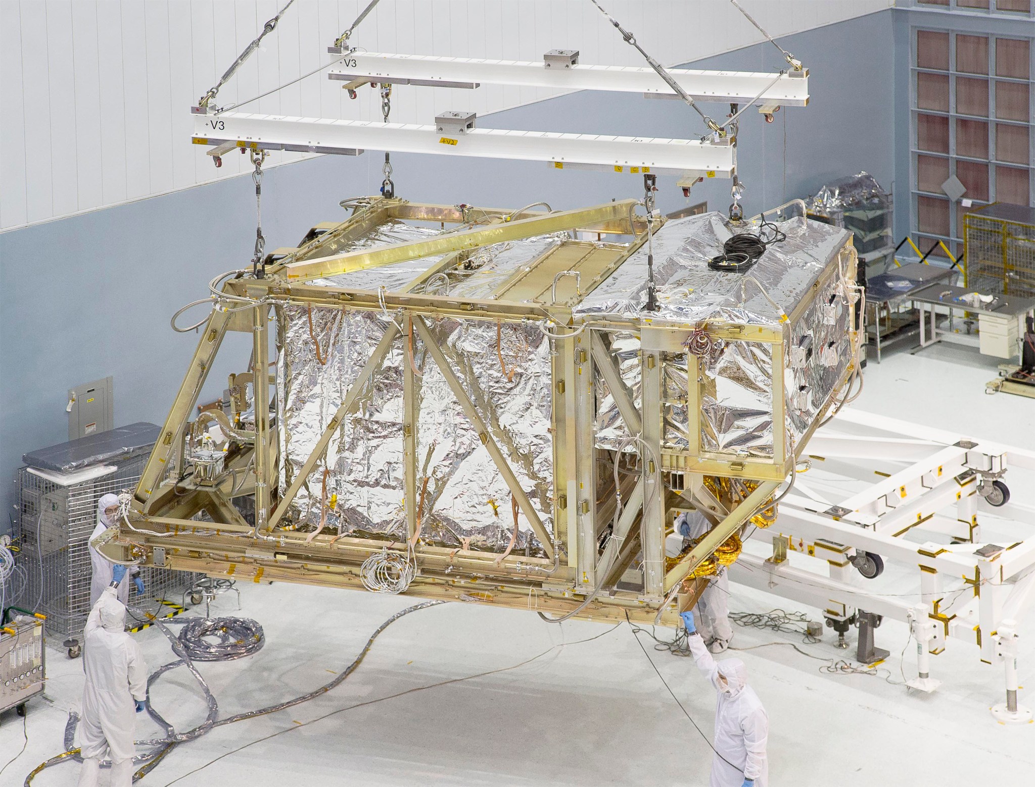 JWST being lifted by crane into the thermal vac chamber.