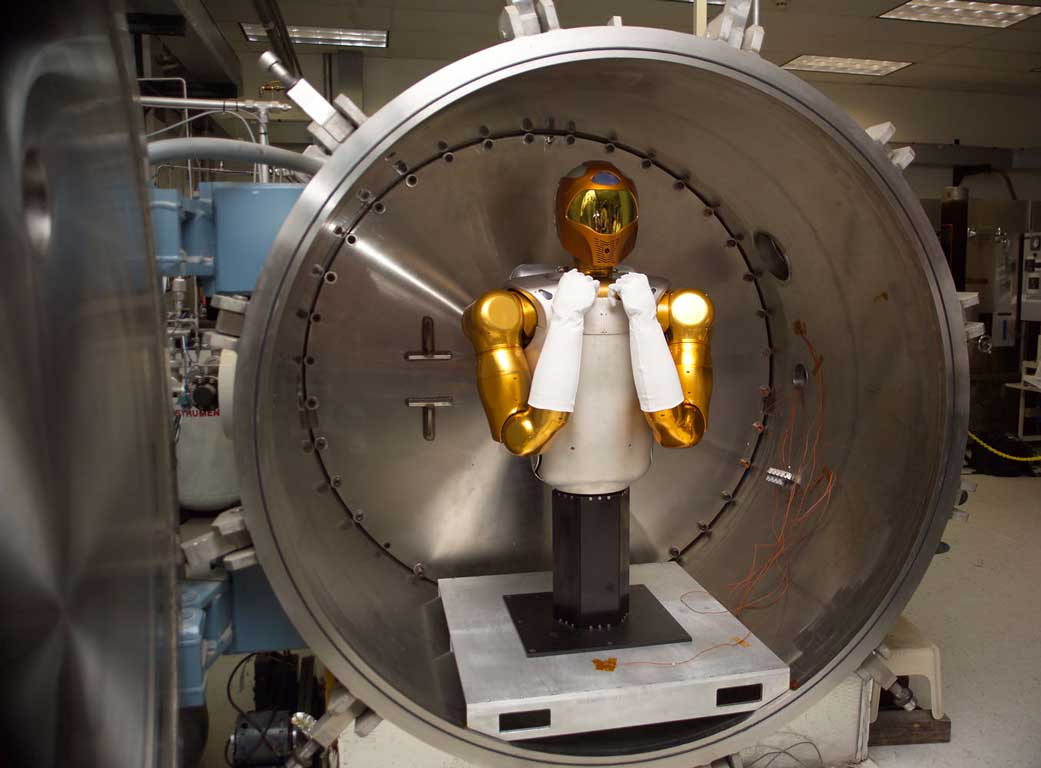 Robonaut and placement into Self Heated Chamber for off gas testing 