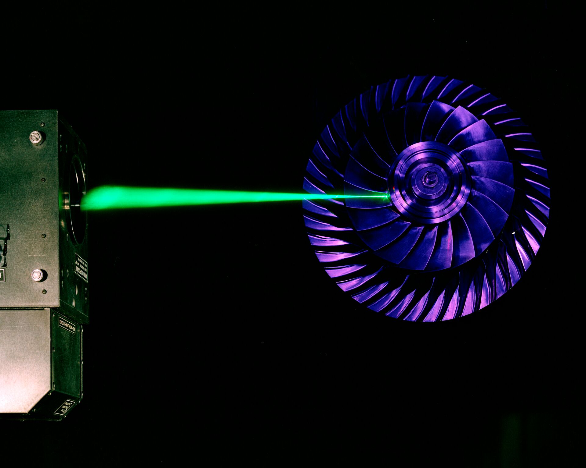 A green laser beam being pointed at an advanced centrifugal compressor.