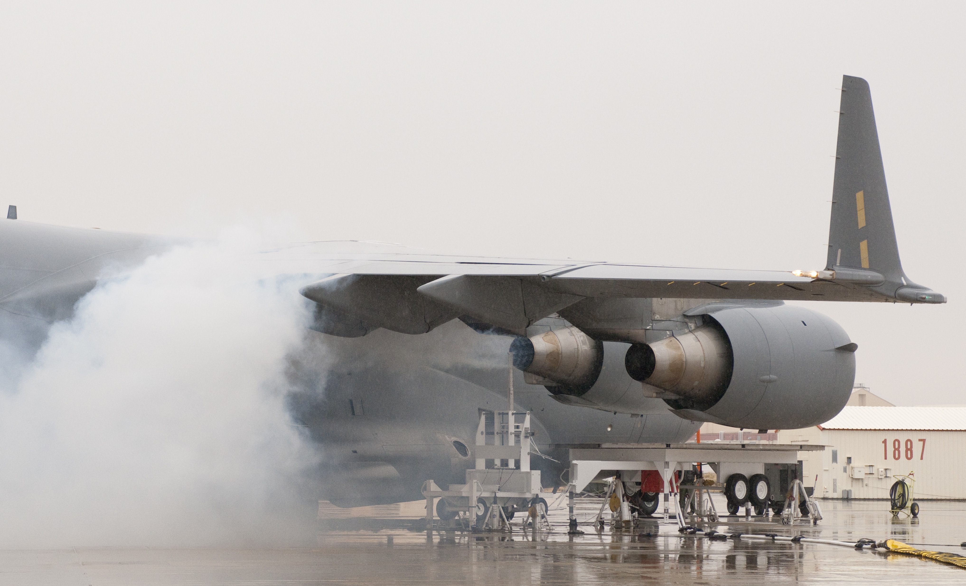 Oil smoke billows from the right inboard engine of the C-17 during engine health monitoring tests.