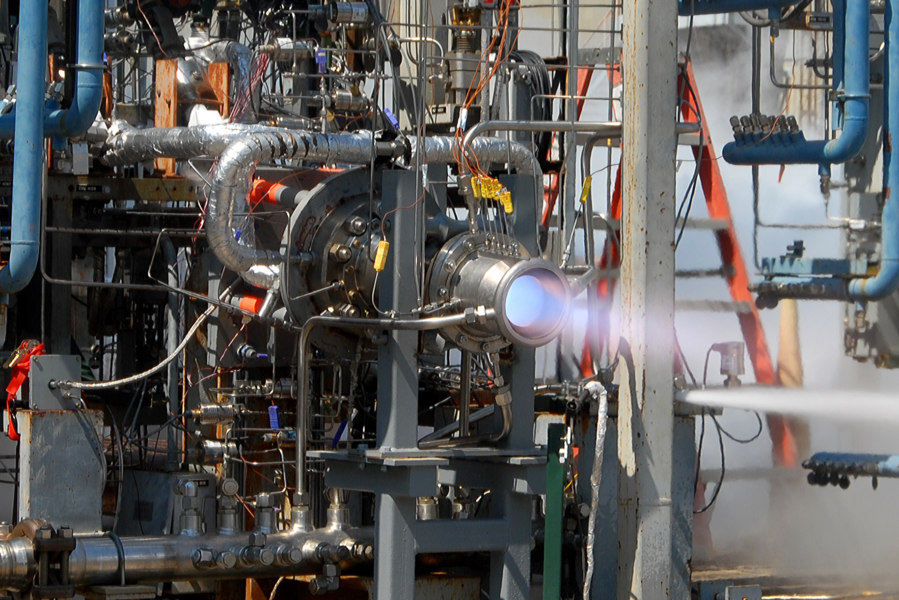 The distinct blue flame in recent tests is produced by the thruster’s fuel, methane.