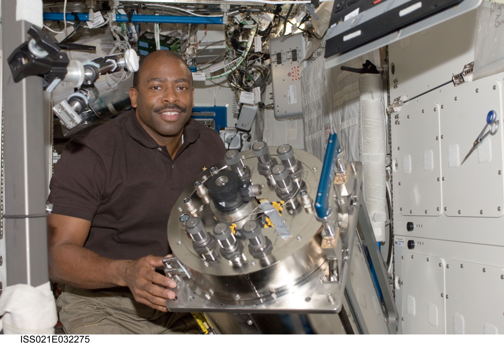 NASA astronaut Leland Melvin removed this early model of the Distillation Assembly from the Water Recovery System.
