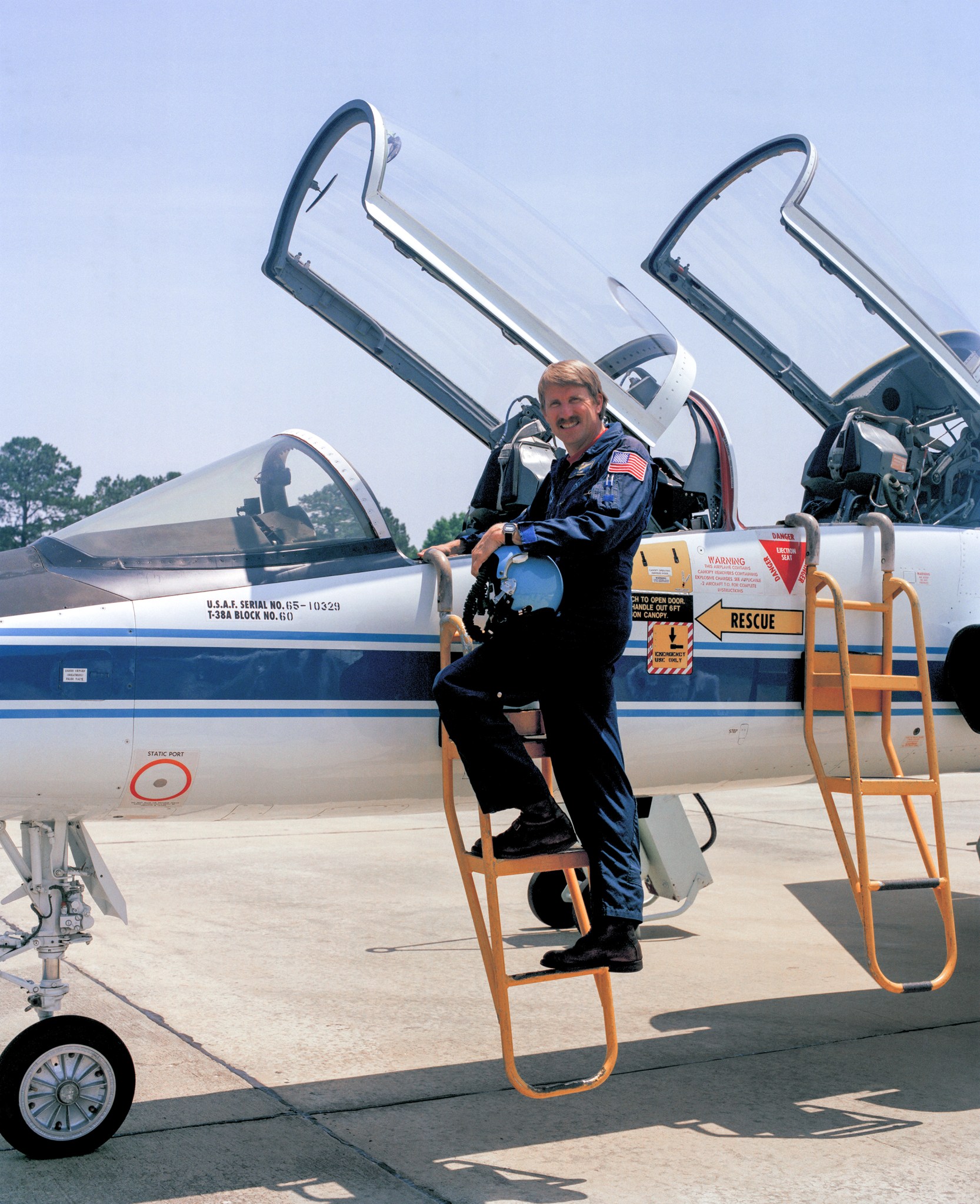 Robert A. Rivers prepares to climb into the cockpit.