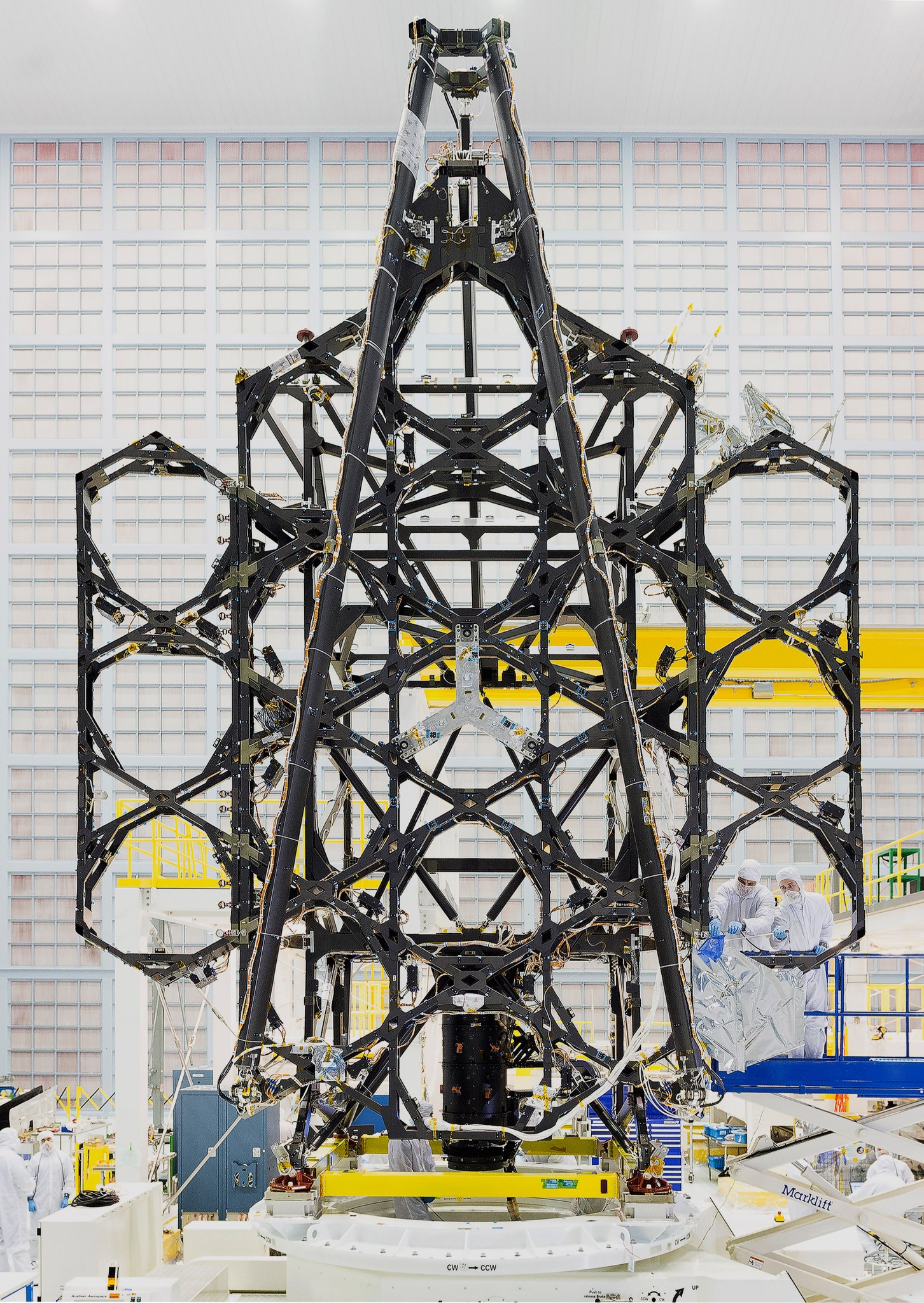 he frame of the Webb telescope primary mirror sitting up right in the clean room. Each mirror segment location has a round frame to hold it in place.