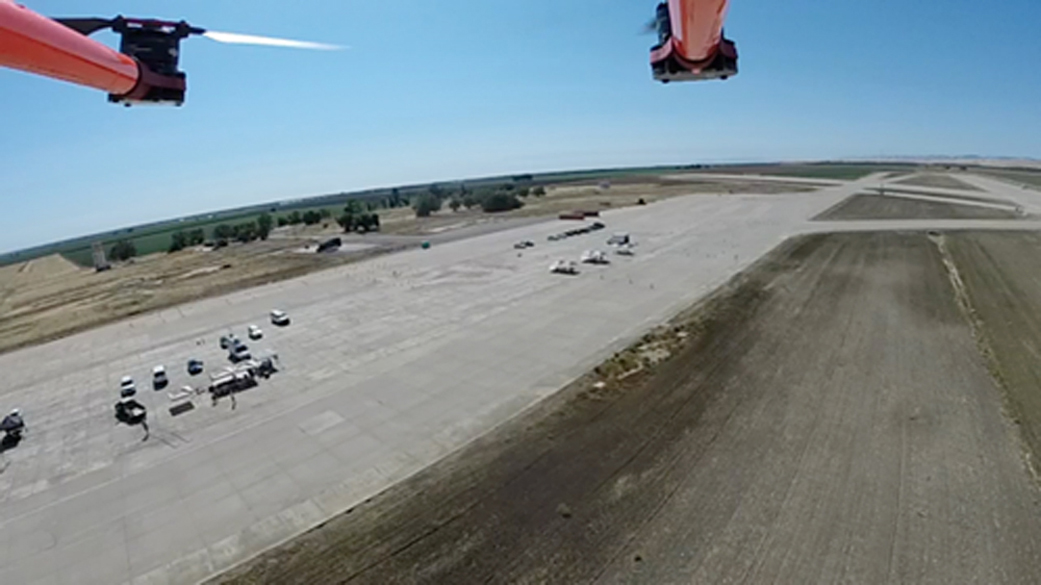 Aerial view of octocopter flying over airfield during airfield test