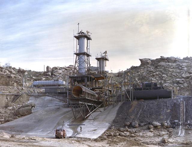 This image depicts an overall view of the vertical test stand for testing the J-2 engine at Rocketdyne's Propulsion Field Laboratory, in the Santa Susana Mountains, near Canoga Park, California.