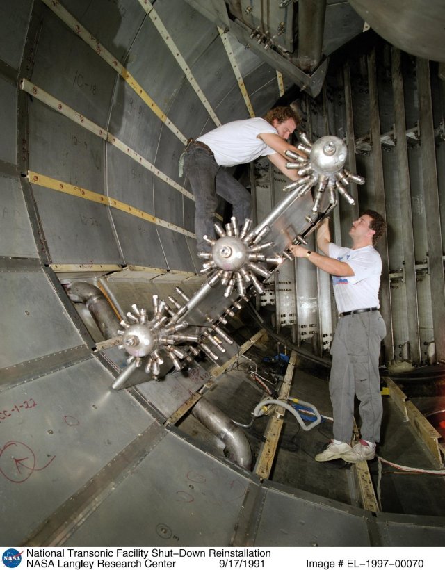 Two NASA employees working on the National Transonic Facility Shut-Down reinstallation.